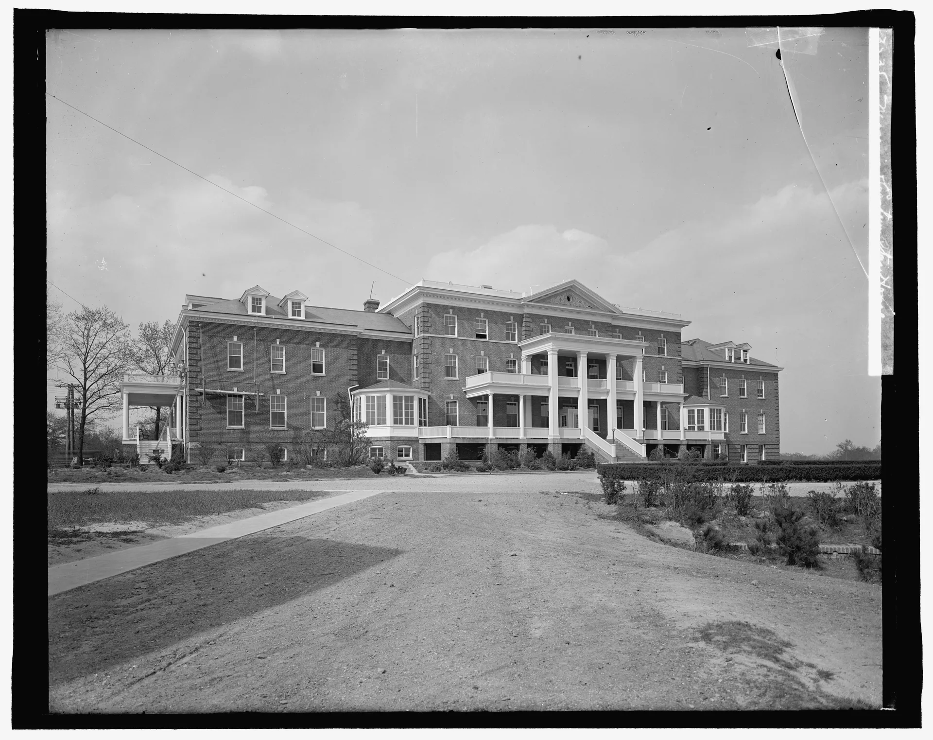 A historic glass-negative photograph cataloged as Masonic and Eastern Star Home, showing a large brick building with a columned entrance and broad lawn.